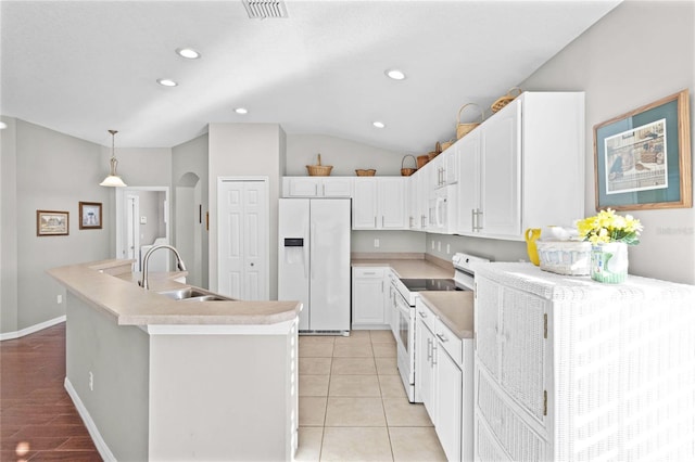 kitchen with white appliances, visible vents, arched walkways, a kitchen island with sink, and a sink