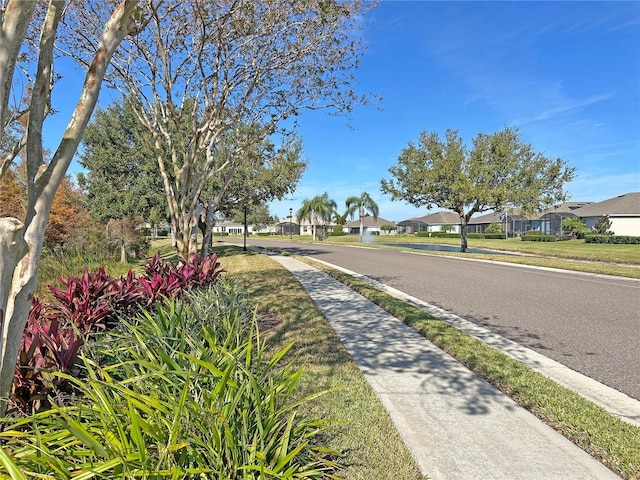 view of street with sidewalks and a residential view