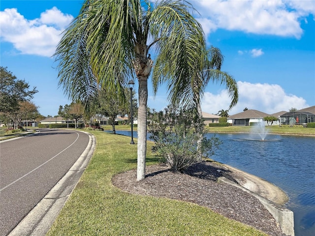 exterior space with a water view and curbs