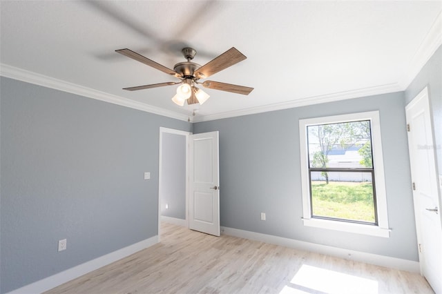 empty room with ceiling fan, ornamental molding, and light hardwood / wood-style flooring