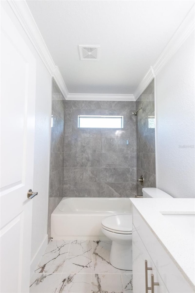 full bathroom featuring tiled shower / bath combo, toilet, crown molding, and vanity