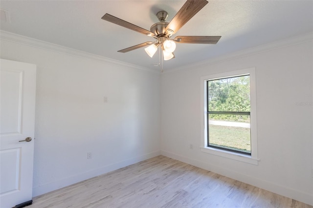 spare room with ceiling fan, ornamental molding, and light hardwood / wood-style flooring