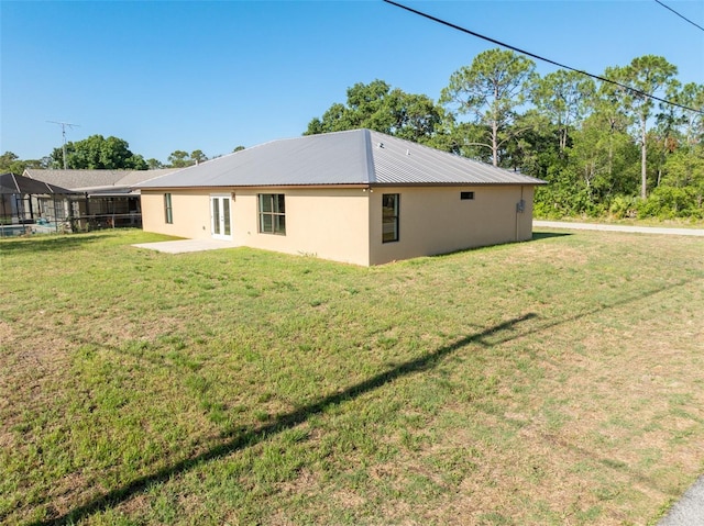 rear view of property with a patio area and a yard