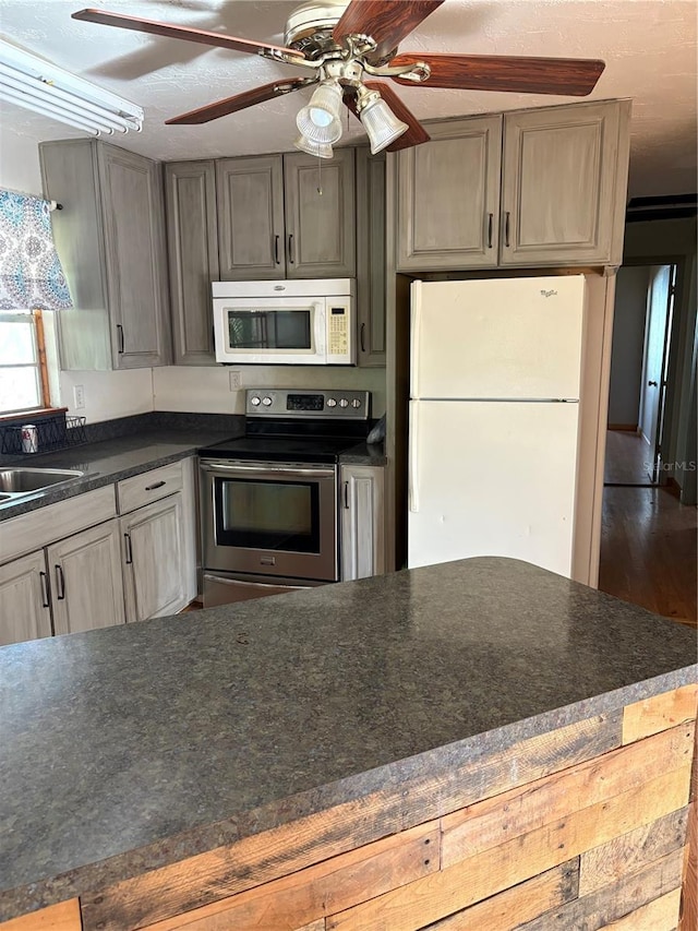 kitchen featuring wood-type flooring, white appliances, and sink