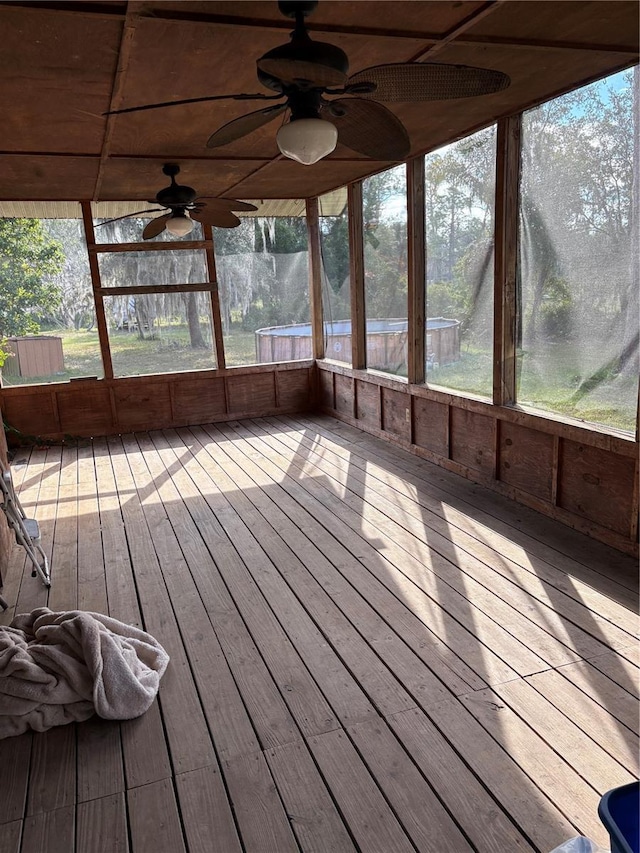 unfurnished sunroom with ceiling fan