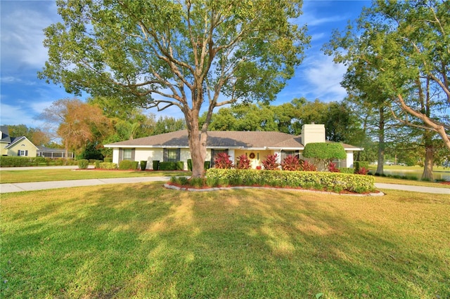 ranch-style house featuring a front lawn