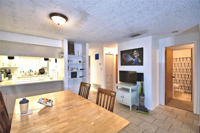 dining area featuring a textured ceiling