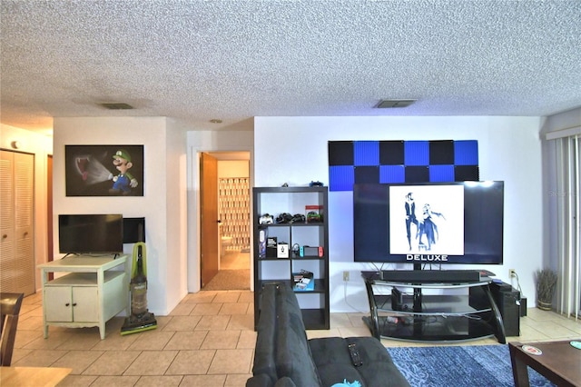 tiled living room featuring a textured ceiling