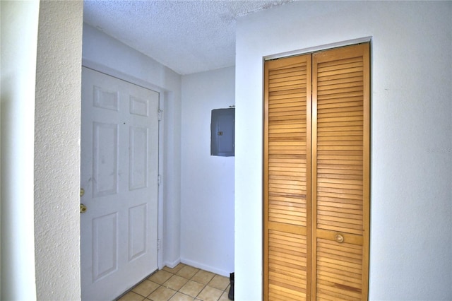 interior space with electric panel and a textured ceiling