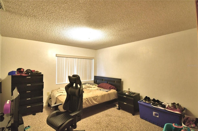 bedroom with carpet floors and a textured ceiling