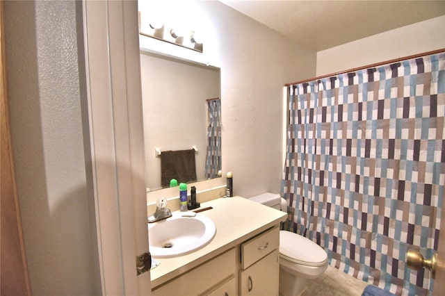 bathroom featuring tile patterned floors, vanity, a shower with shower curtain, and toilet