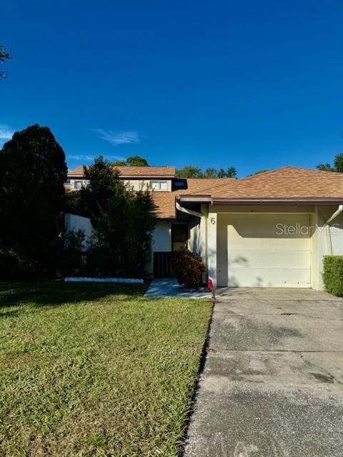 view of front of property with a front yard and a garage