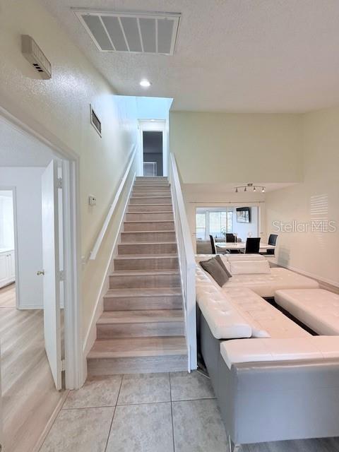 stairway featuring tile patterned floors