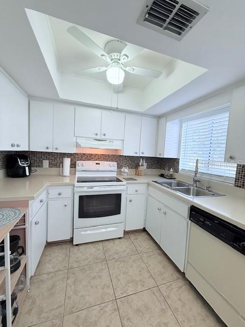 kitchen featuring sink, white cabinets, and white appliances