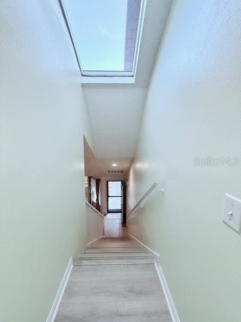 stairway featuring hardwood / wood-style flooring