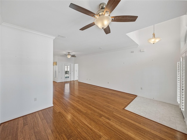 unfurnished living room with ceiling fan, ornamental molding, and hardwood / wood-style flooring