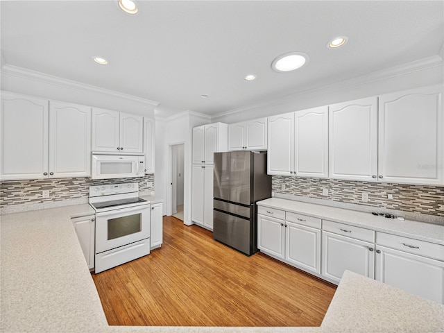 kitchen featuring light hardwood / wood-style flooring, backsplash, white appliances, white cabinets, and ornamental molding