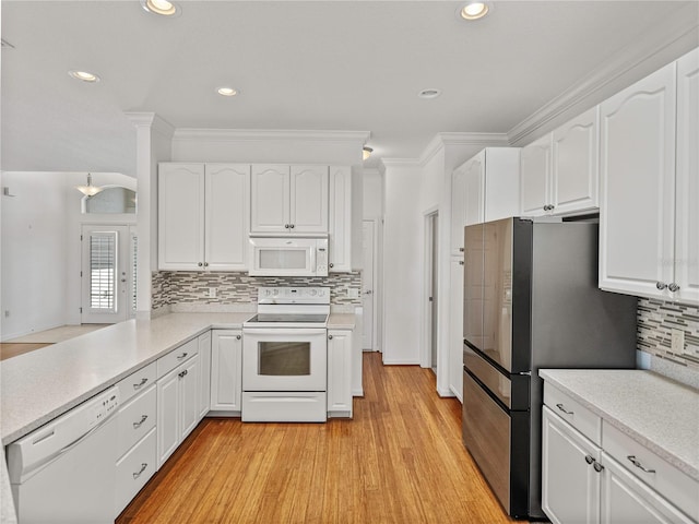 kitchen featuring white cabinets, light hardwood / wood-style floors, white appliances, and crown molding