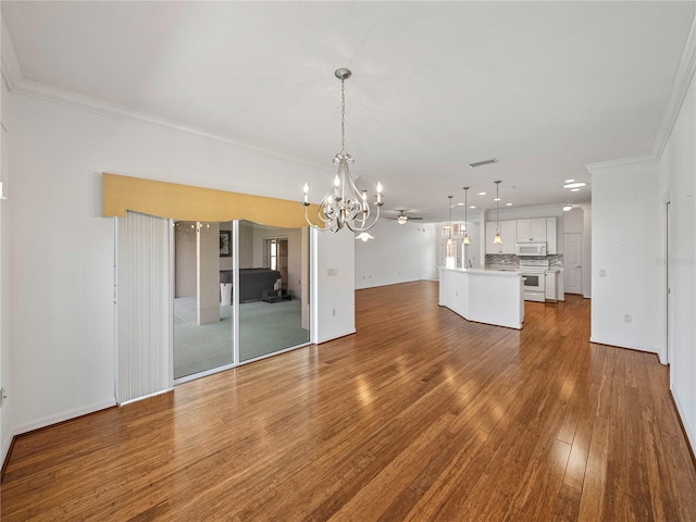 interior space featuring ceiling fan with notable chandelier, hardwood / wood-style flooring, and crown molding