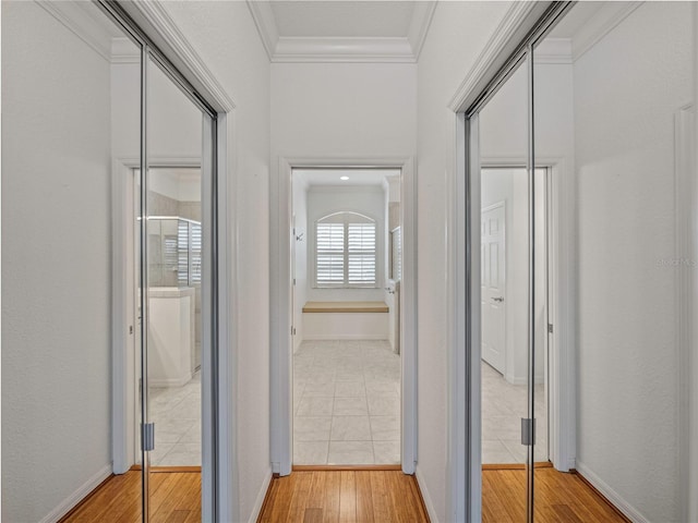 hall with wood-type flooring and crown molding