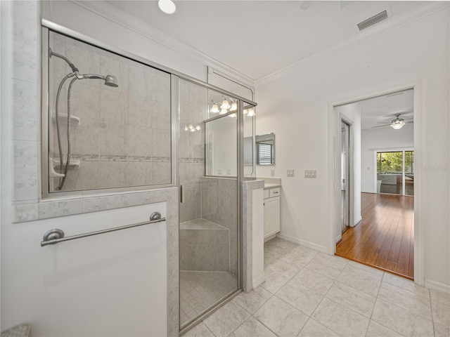 bathroom with an enclosed shower, ornamental molding, vanity, ceiling fan, and hardwood / wood-style flooring