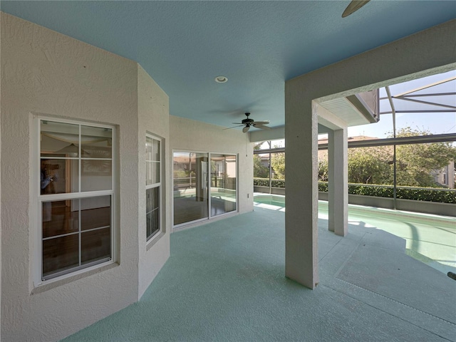 view of patio featuring a lanai and ceiling fan