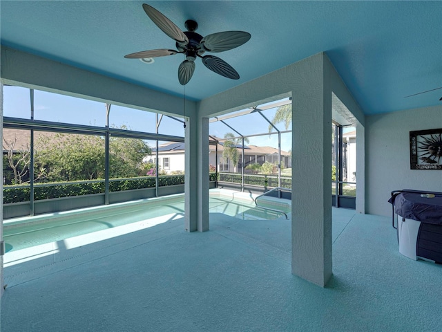 view of swimming pool featuring ceiling fan, a patio area, and a lanai