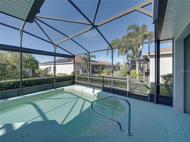 view of swimming pool featuring a lanai