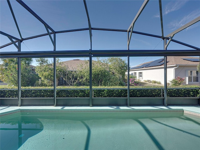 view of swimming pool with a lanai