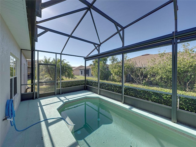 view of swimming pool featuring a lanai