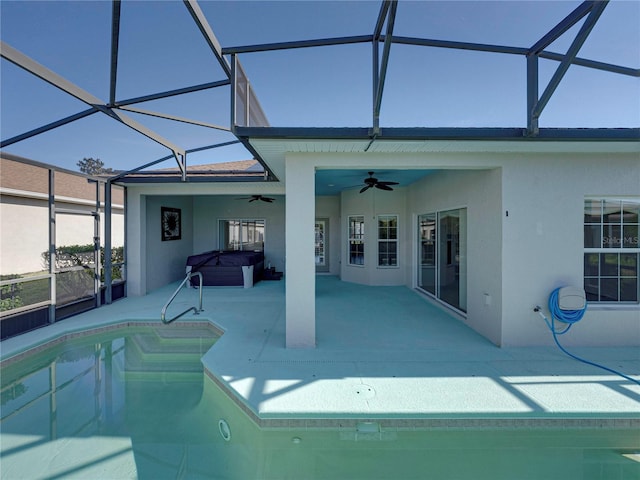 view of pool with ceiling fan, a lanai, and a patio