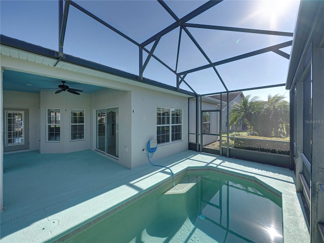 view of pool with a lanai, ceiling fan, and a patio