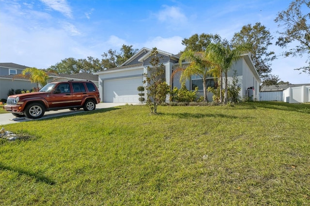 view of front of home with a garage and a front lawn