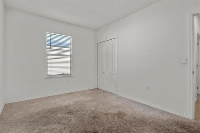 spare room featuring light carpet