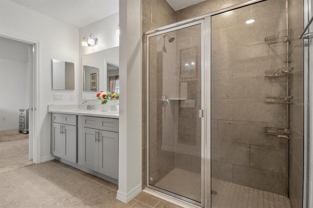 bathroom featuring vanity, tile patterned floors, and a shower with shower door