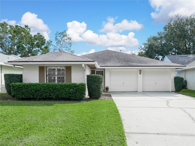 single story home featuring a front lawn and a garage