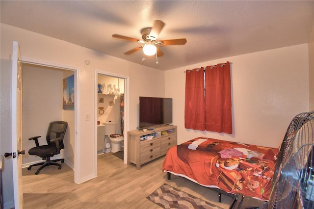 bedroom with ensuite bath, light hardwood / wood-style flooring, and ceiling fan