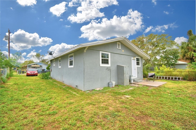 rear view of house with a yard and a patio area