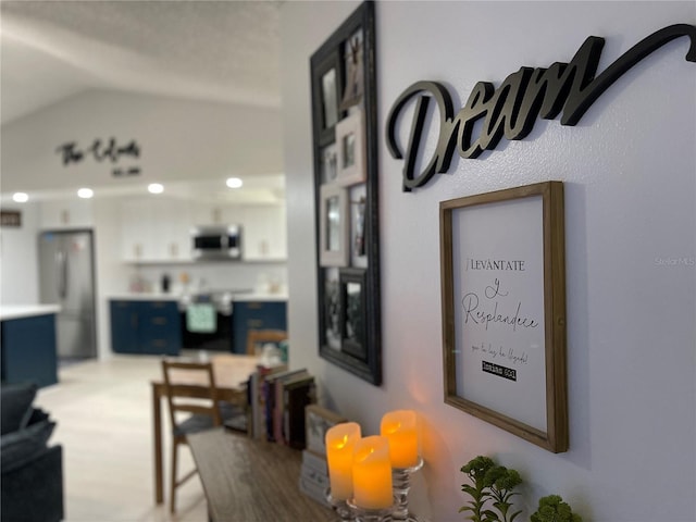 dining area featuring wood-type flooring and vaulted ceiling