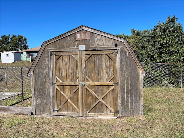 view of outbuilding with a yard