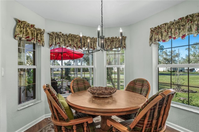 sunroom featuring an inviting chandelier and a healthy amount of sunlight