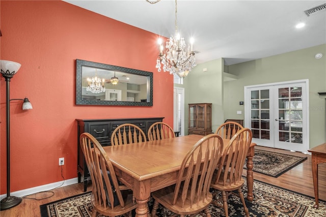 dining area featuring french doors, an inviting chandelier, and wood-type flooring