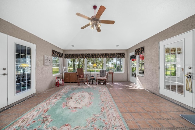 unfurnished sunroom with vaulted ceiling, plenty of natural light, and ceiling fan