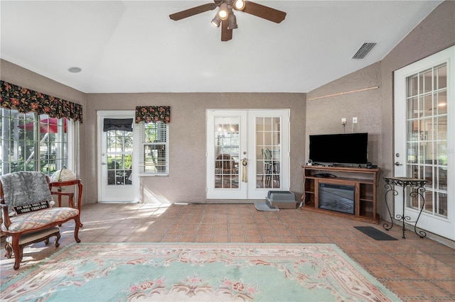 living room with ceiling fan, lofted ceiling, and french doors