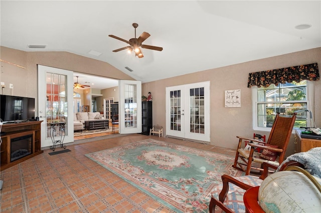 tiled living room with french doors, vaulted ceiling, and ceiling fan