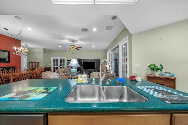 kitchen with ceiling fan with notable chandelier, sink, and french doors