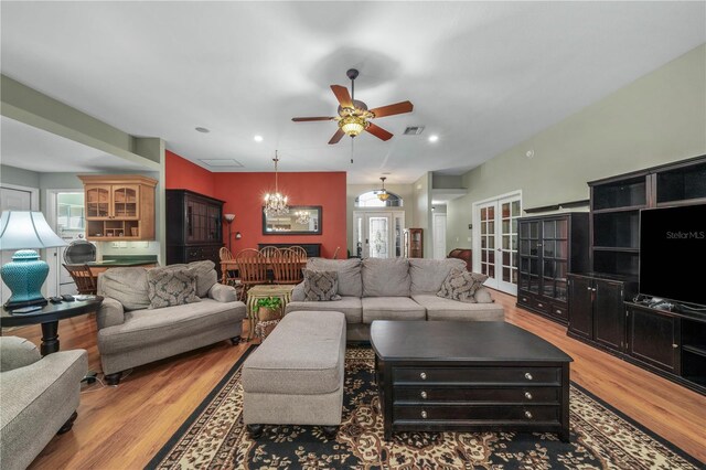 living room featuring hardwood / wood-style floors, french doors, and ceiling fan