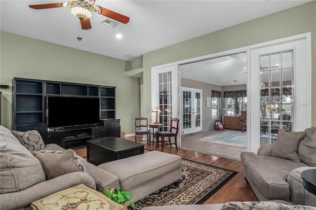 living room with ceiling fan, french doors, and wood-type flooring