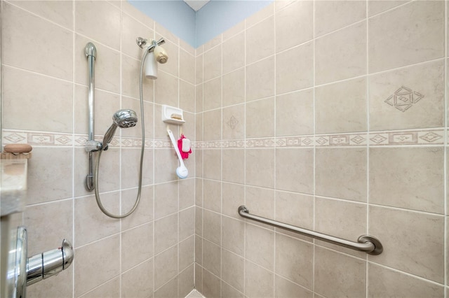 bathroom with a tile shower