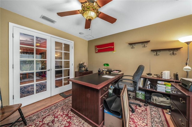 office with hardwood / wood-style floors, ceiling fan, and french doors